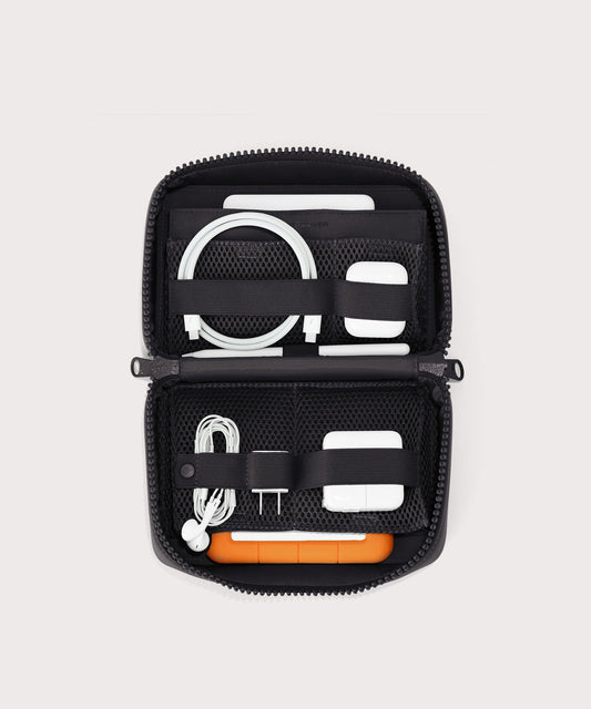 hover - Dagne Dover large Arlo Tech Organizer in black unzipped, revealing the interior elastic loops and airmesh pockets.