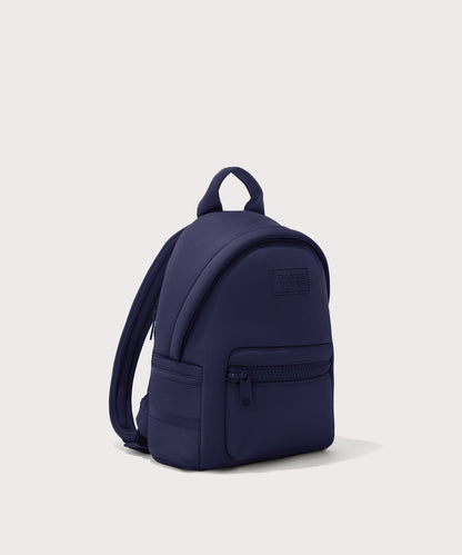 Dagne Dover small Dakota Neoprene Backpack in dark blue seen from an angle.