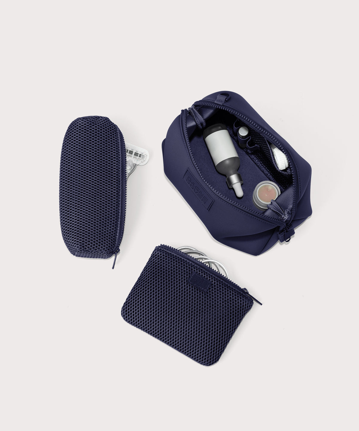 Dagne Dover Large Hunter Toiletry Bag in dark blue unzipped and seen from above with the removable air mesh pouch alongside it.