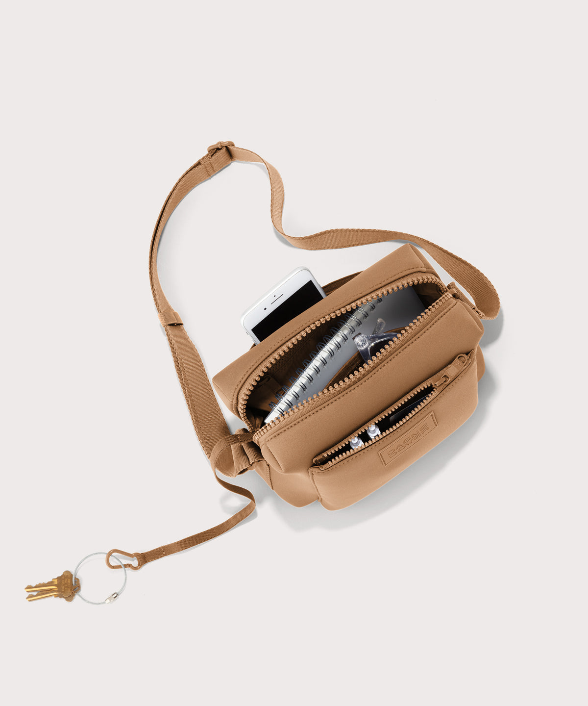 Dagne Dover Micah Crossbody in brown camel seen from above, showing the interior air mesh pocket.