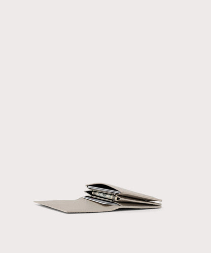 hover - Dagne Dover Accordion Card Case in white opened, revealing the three internal gusseted card slots.