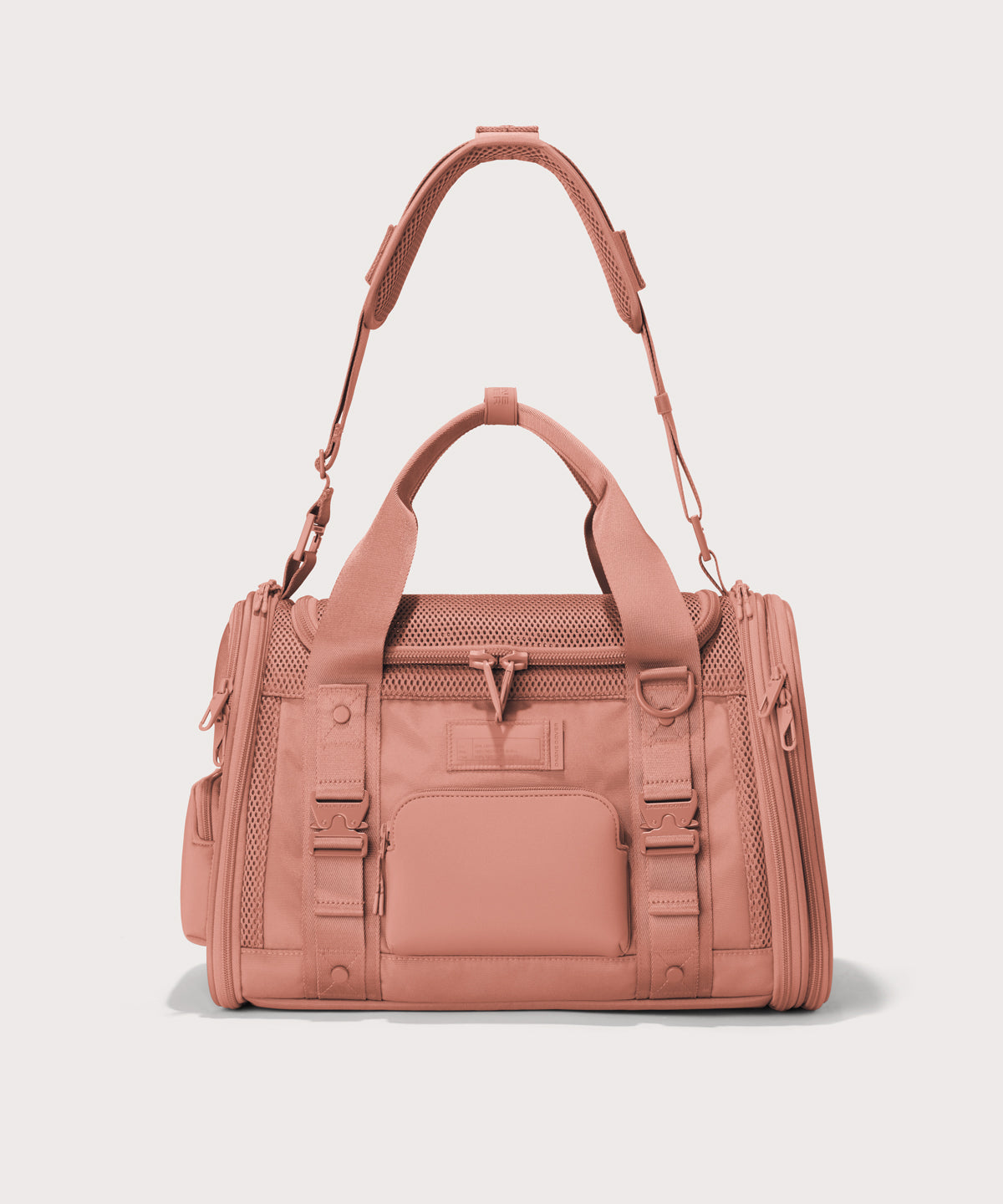 Dagne Dover small Kyoto Pet Carrier in a warm dust pink seen from the front with crossbody strap.
