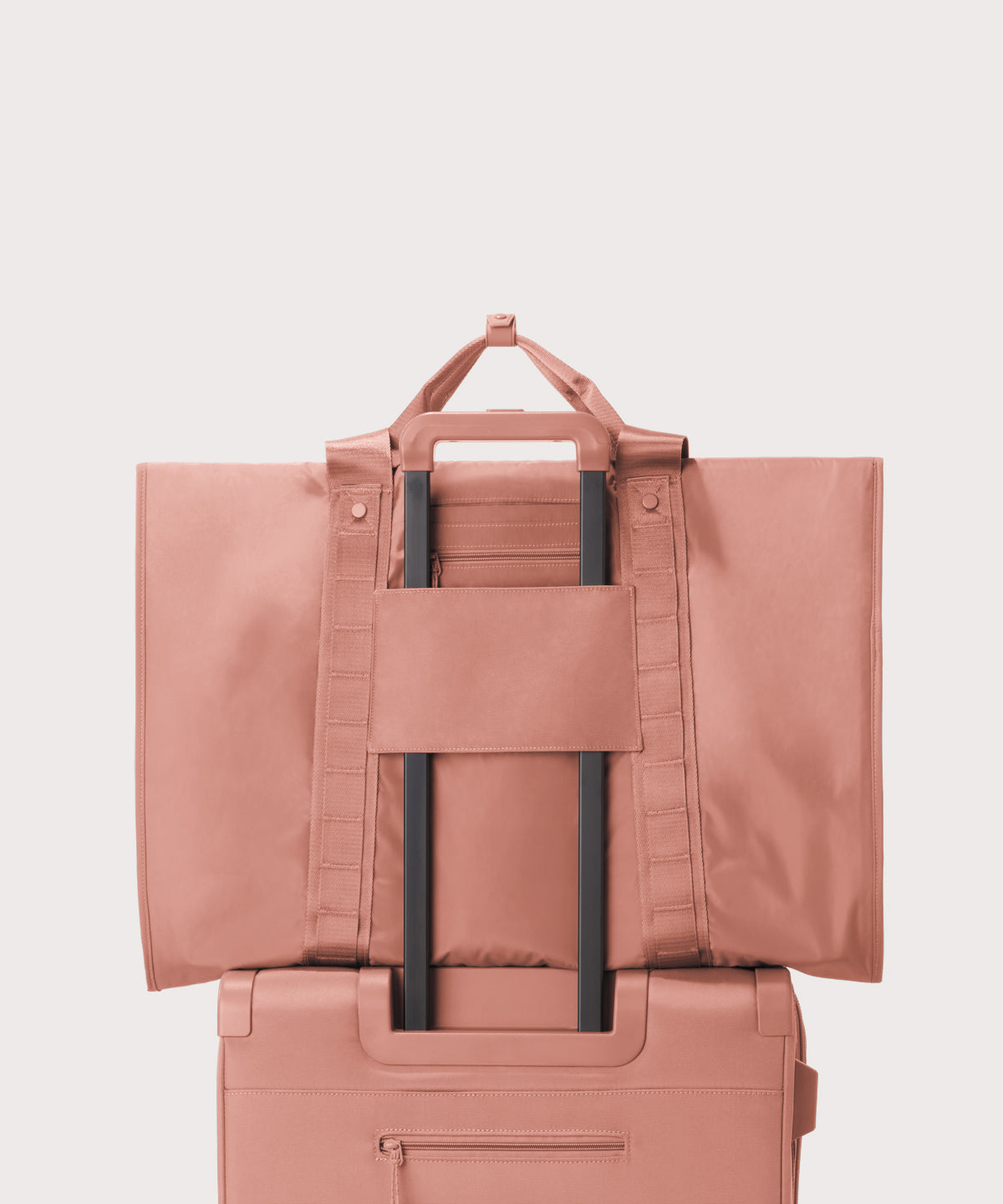 Back view of Capri garment bag in warm dust on luggage handle