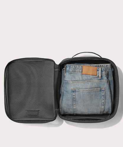 Large Roma packing cube in carbon black open with jeans inside