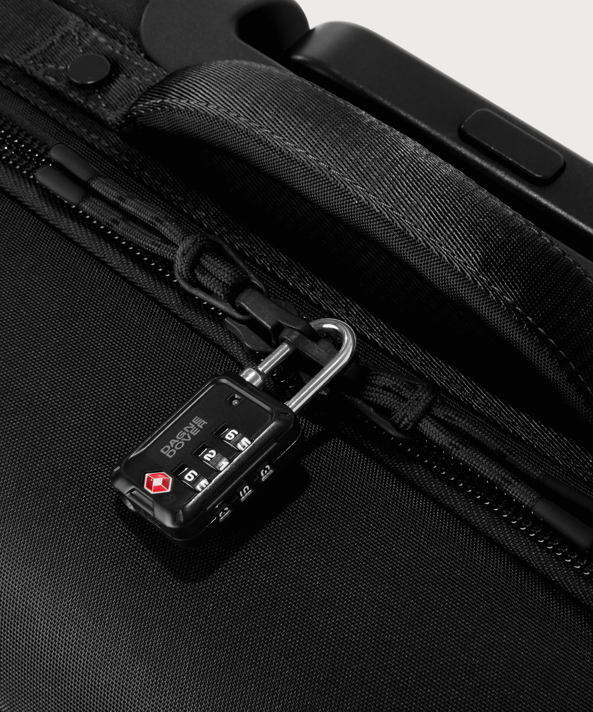 Detail shot of Sydney checked rolling luggage 25" in black lockable zipper heads. Lock not included.