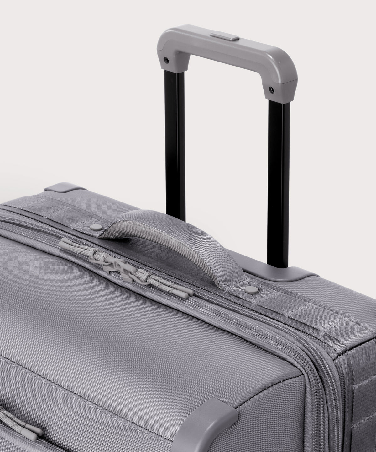 Detail shot of Sydney checked rolling luggage 28.5” in light grey extended luggage handle and puffy handle