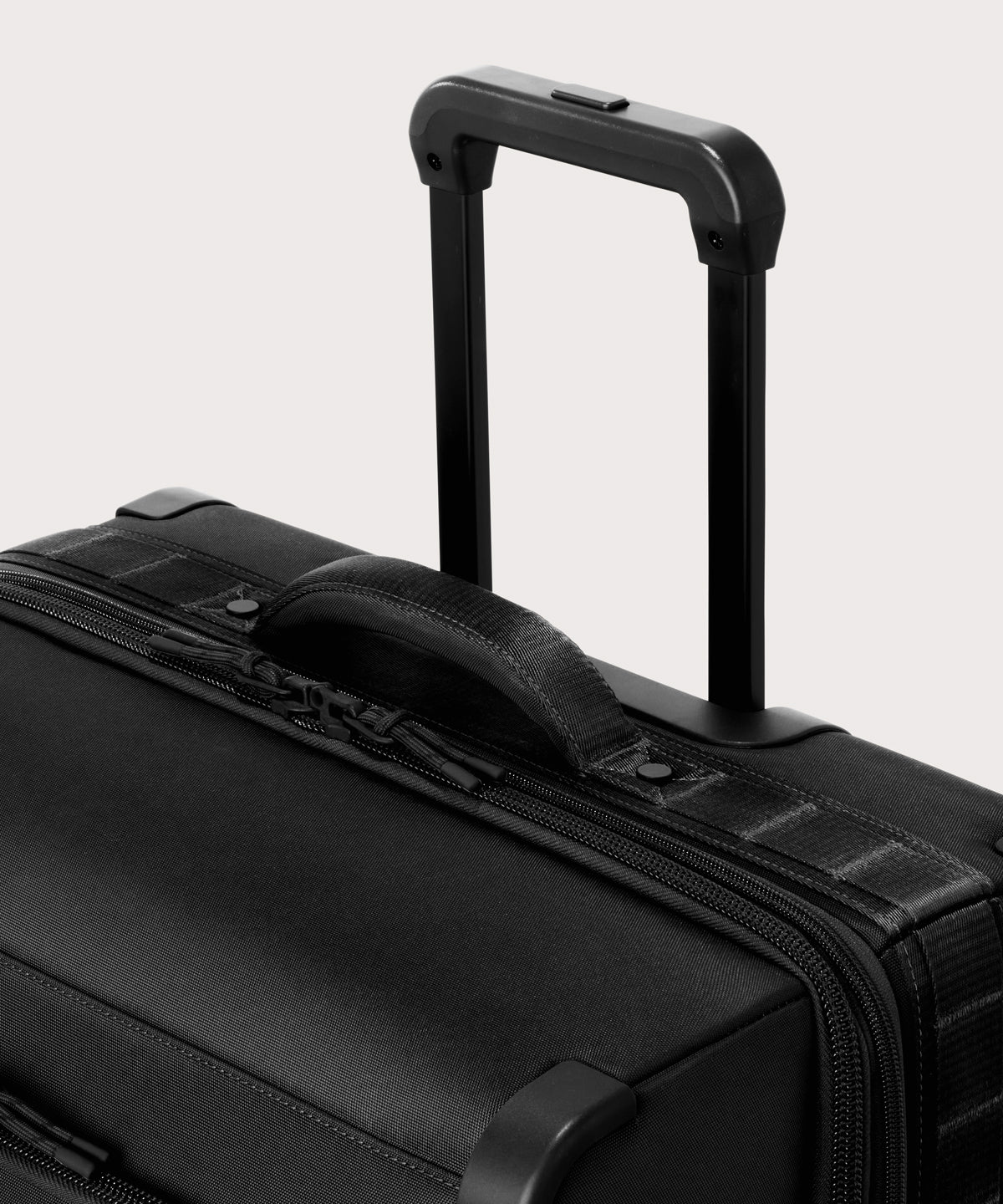 Detail shot of Sydney checked rolling luggage 25" in black extended luggage handle and puffy handle